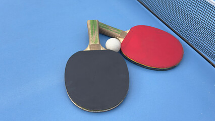 Table tennis rackets and ball on tennis table