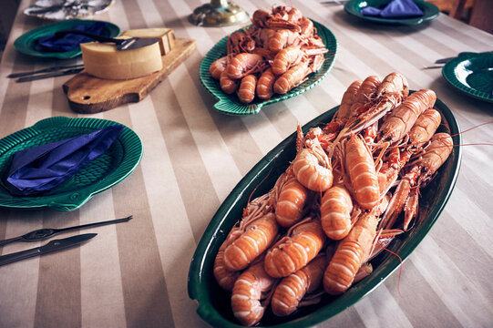 Cooked shrimps with full shell in bowls on dining table