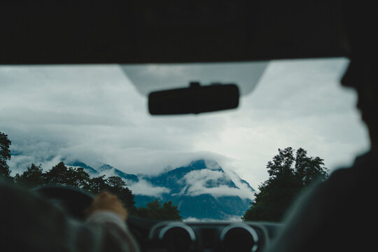 Mountain range seen through windshield of car