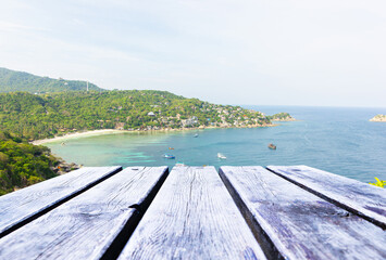 Bird's-eye view of Empty grey, brown wooden floor or table. Sea and beach, rocks, mountain evening bright sunshine sky is background Summer of clear blue water and many tourist boats.