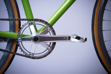 wheel of a bicycle, bike pedal, chain and green frame