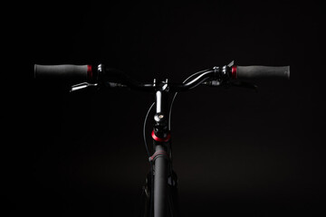 bicycle handlebar, bike isolated on black studio backdrop, bike part details