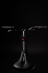 bicycle handlebar, bike isolated on black studio backdrop, bike part details