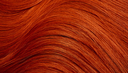 Red hair close-up as a background. Women's long orange hair. Beautifully styled wavy shiny curls....