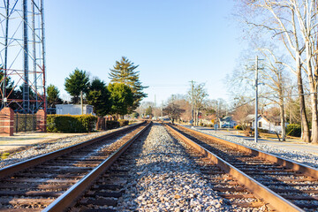 The train tracks are empty and the sky is clear