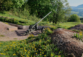 gun position behind wire barriers in trench. anti-tank measures made of metal hedgehogs that get...
