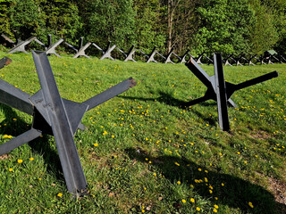 gun position behind wire barriers in trench. anti-tank measures made of metal hedgehogs that get...