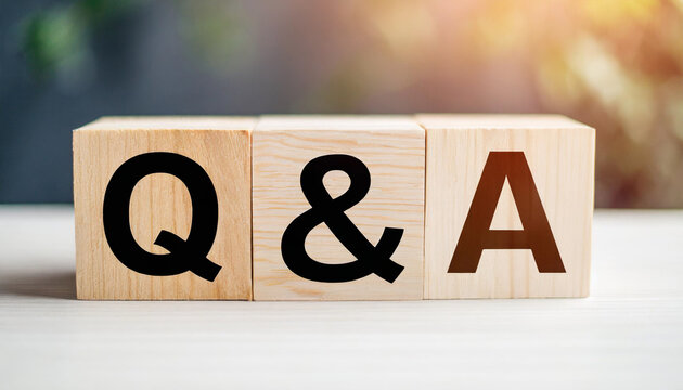 Wooden blocks spelling "Q&A" on a white table symbolize communication, inquiry, and information exchange, often used in business, education, and customer support contexts