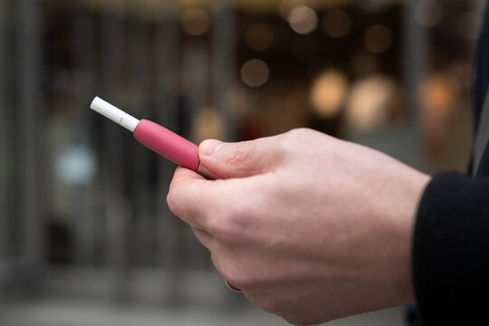 Man holding electronic cigarette in his hand