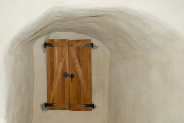 Rustic Wooden Door Against Textured Cave-Like Wall