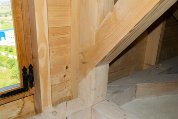 Detailed view of wooden beam structure joint in an architectural framework, showcasing the craftsmanship and intricate woodworking in a construction project.