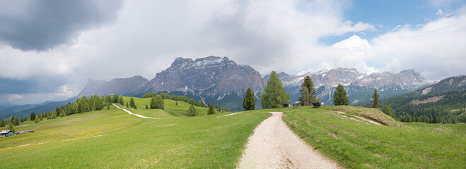 hiking trail on the plateau of Pralongia to Piz Sorega, Dolomites alps with thunderclouds