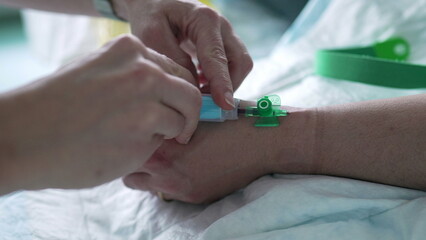 Nurse's hand taking blood from Patient's hand, close-up. hospital equipment and routine of nursing care
