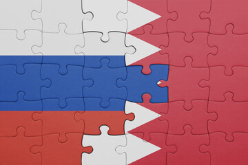 Fototapeta premium puzzle with the colourful national flag of bahrain and flag of russia.
