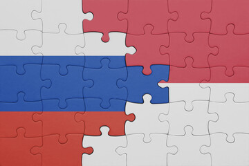 puzzle with the colourful national flag of indonesia and flag of russia.