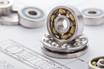 different bearings on blue print background. Part of mechanism.