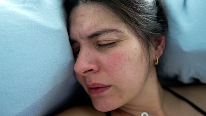Close-up face of 30s woman struggling with pain during childbirth, real life lady experiencing...