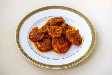 Tasty Bengali food shrimp fish curry or chingri bhuna served on a white plate. Chingri vuna or prawn curry is a Bangladeshi-style dish with spicy gravy.