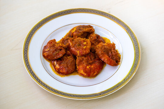 Tasty Bengali food shrimp fish curry or chingri bhuna served on a white plate. Chingri vuna or prawn curry is a Bangladeshi-style dish with spicy gravy.