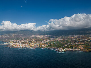 ocean shore with blue water and city Puerto De La Cruz, Tenerife, Canary island