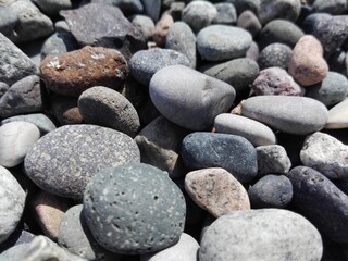 Top view of rounded Sea Pebble stones and rocks on beach. Pebbles as natural abstract texture or background. Pebbles on seacoast in Batumi.