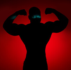 Shadow, muscle and man flexing, fitness and challenge for wellness on red studio background....