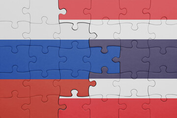 puzzle with the colourful national flag of thailand and flag of russia.