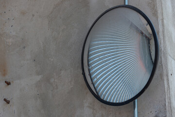 abstract convex mirror outside a garage door entrance or exit
