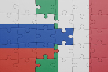 puzzle with the colourful national flag of italy and flag of russia.