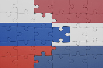 puzzle with the colourful national flag of netherlands and flag of russia.
