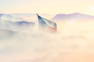 Czech Republic flag disappears in beautiful clouds with fog.