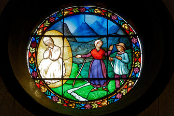 A stained glass of the apparition of Our Lady of La Salette. Sanctuary Notre-Dame de La Salette, France. Vitrail de l'apparition de la Vierge Marie. Sanctuaire de Notre-Dame de La Salette.