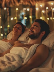 Fototapeta premium A man and a woman are lying in bed, both smiling and looking relaxed