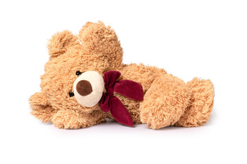 Brown teddy bear lying down  isolated on white background.