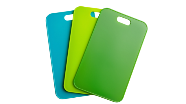 Three plastic cutting boards in different colors - red, blue, and green, stacked neatly on a kitchen counter