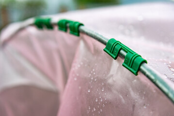 The garden bed on plastic arches. Gardening poly tunnel for farming of vegetables.