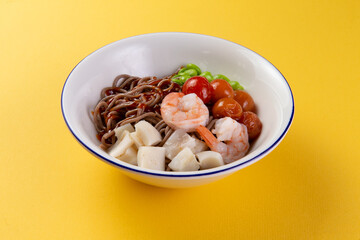 Buckwheat noodles with seafood in a plate.