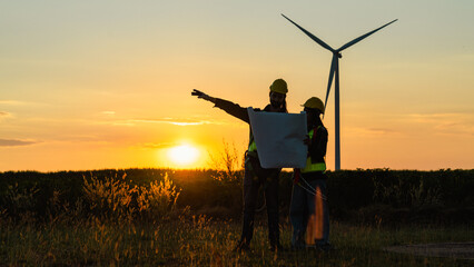 Engineer and energy farming. windmills with the silhouette of a sunset background.