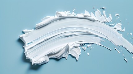 White cream swatch on blue background, top view. Abstract smudge shape with copy space for text or design.
