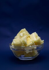 Closeup of Butter in a Small Glass Bowl Isolated on Black Background with Copy Space