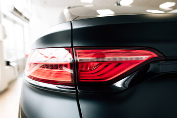 Modern rear light on new matte black automobile