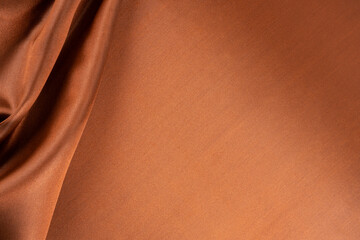 Brown background luxury cloth or wavy folds of grunge silk texture.