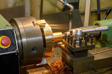 The lathe machine finish cut the brass material parts by lathe tools.