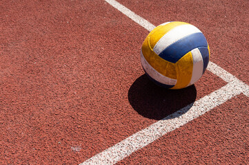 volleyball. blue with yellow color ball on the playground. volleyball cover, red. ball game