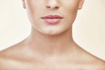 Woman, lips and mouth in studio for beauty with makeup, cosmetics and glow with pride for...