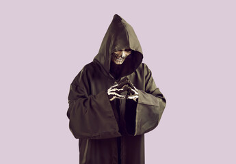 Grim reaper is planning something bad and is smiling ominously while gesturing with his fingers....