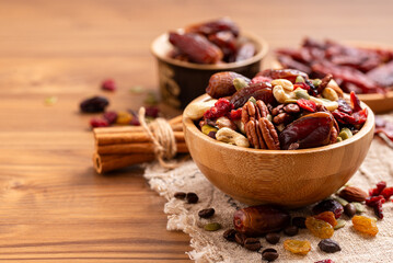 Natural raw foods ingredients and nuts arranged on a wooden table in a flat layout copy space image...
