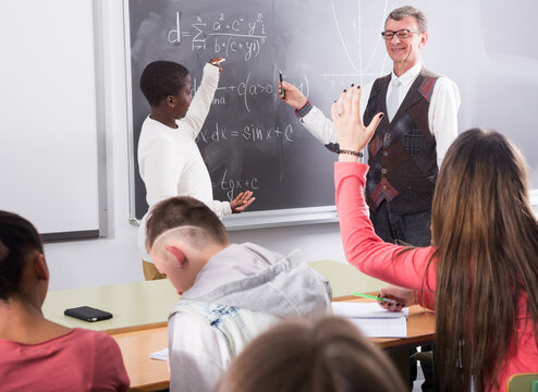 Student answers on the board during math lesson