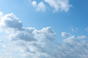 Bright blue sky with fluffy white clouds on a sunny day