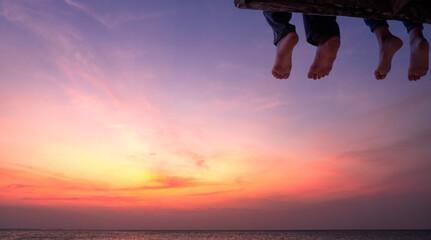 foots friend on sunset over sea